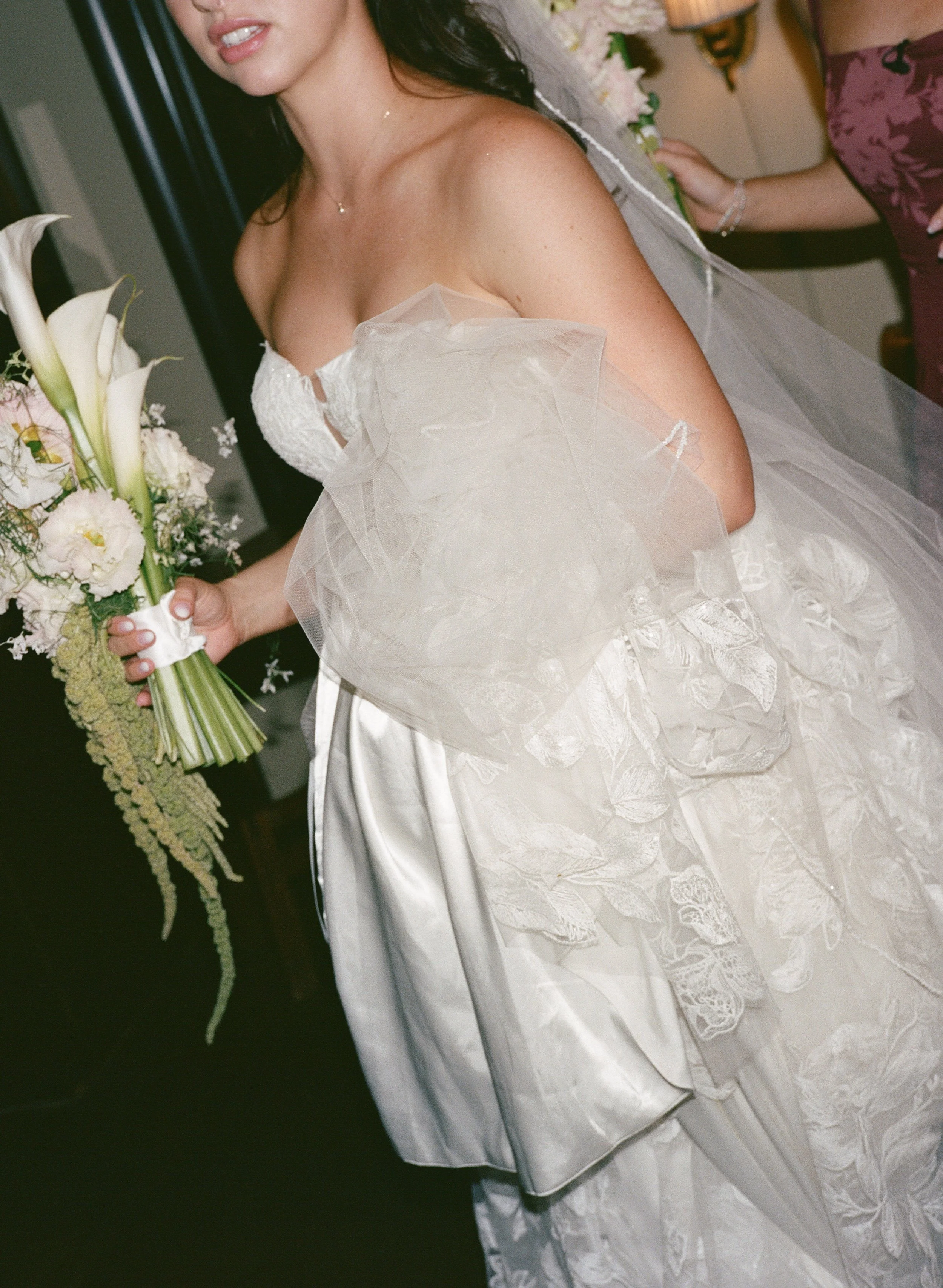  Garden-inspired wedding at JM Cellars featuring green and burgundy details, film photography, and an outdoor winery setting. Candid bridal in between moment 