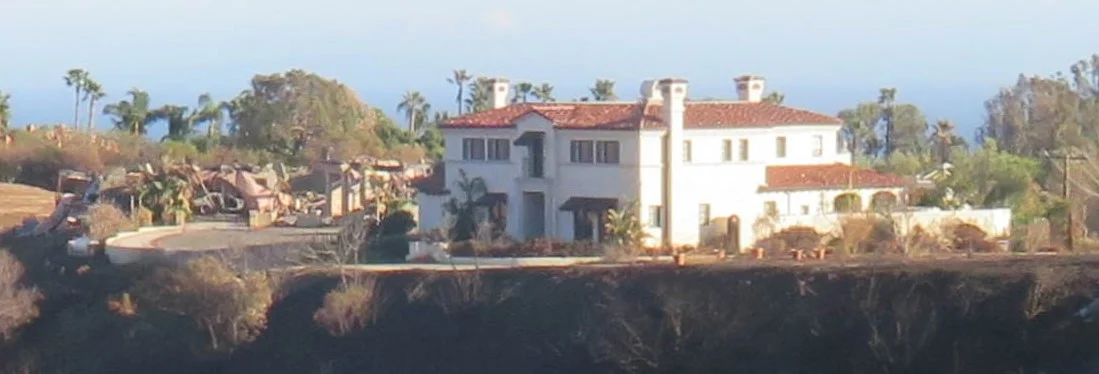 This house was built to withstand a fire. Notice the large driveway that goes completely around the house, creating a barrier for the flames. The garage to the left was not so lucky and was destroyed by the fire.