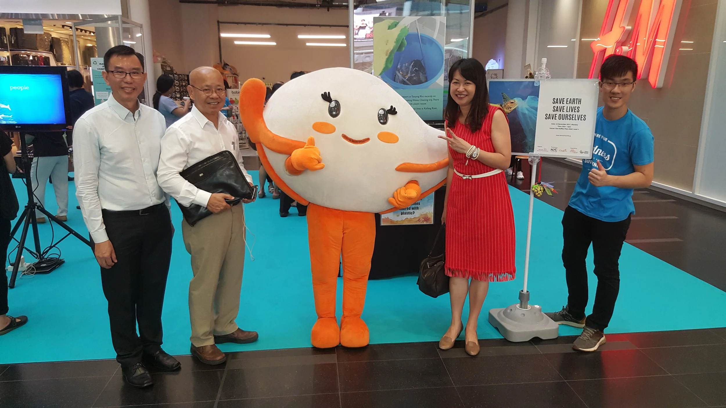 Our esteemed Community Partner Dr William Wan, General Secretary of the Singapore Kindness Movement posing for a picture with our lively mascot Eco Eva, supported by Ministry of the Environment and Water Resources (MEWR). Alongside him is Blossom World Society’ CEO, Mr Ang Choon Tee (far left), Founder of Blossom World Society, Ms Jennifer Goh (2nd right) and the Project Leader for “Save Earth Save Lives Save Ourselves”, Jeremy Ng (far right).