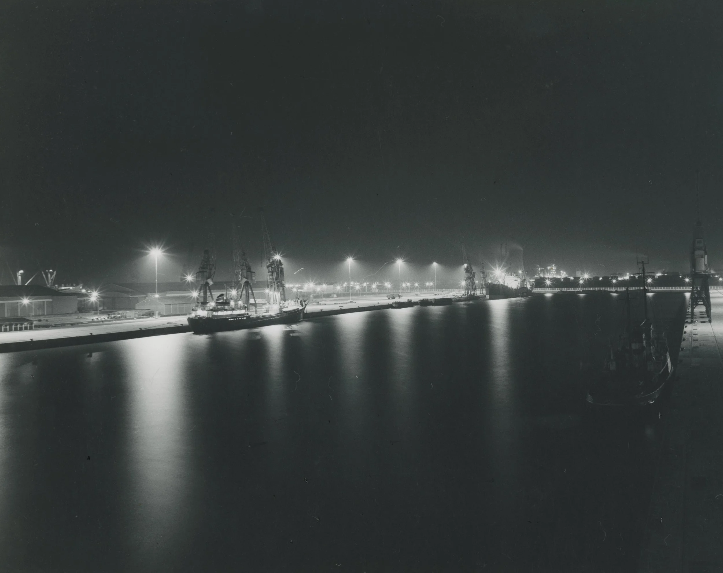 A view over the floodlit dock at night. Queen Elizabeth Dock, Hull. August, 1969. Photographer - Donald I. Innes Commissioned by ABP.