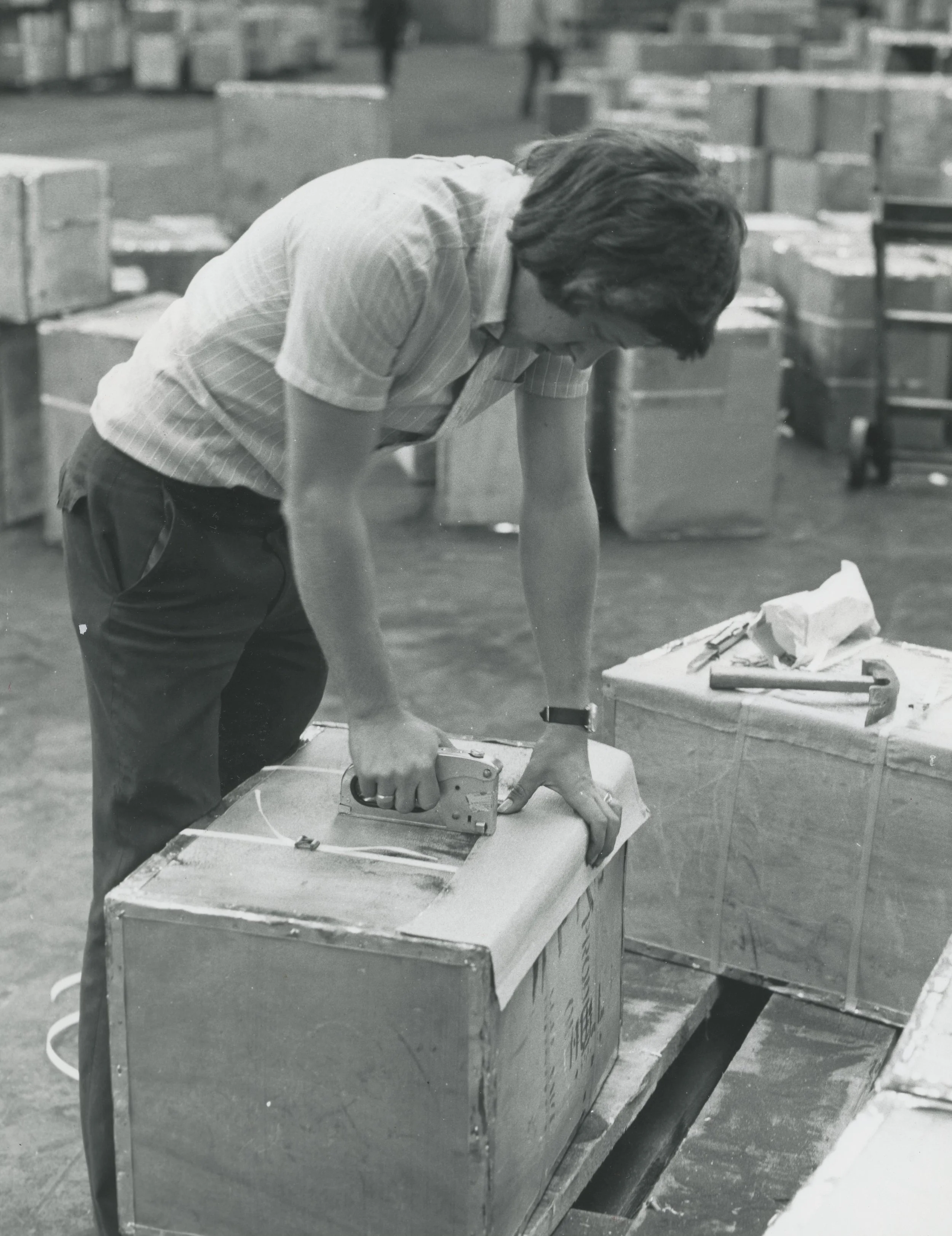 A worker coopering chests of tea in No. 8 Shed. King George Dock, Hull. Photographer - Herbert Ballard Commissioned by ABP.