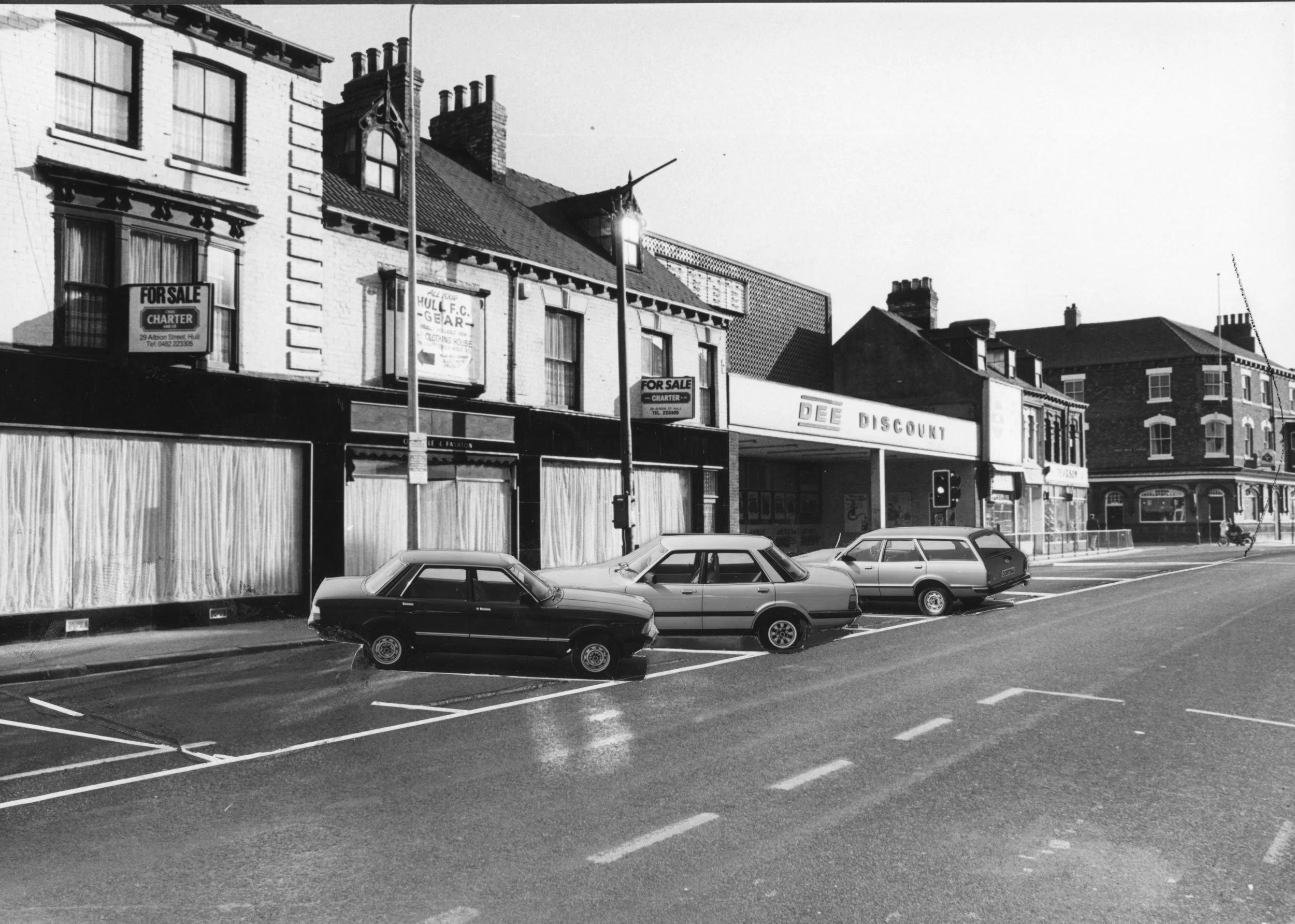 Hessle Road, looking towards Rayner's, with glued-on cars: could this be Hessle Road in years to come? 16-07-1982. Commissioned by Hull Daily Mail.