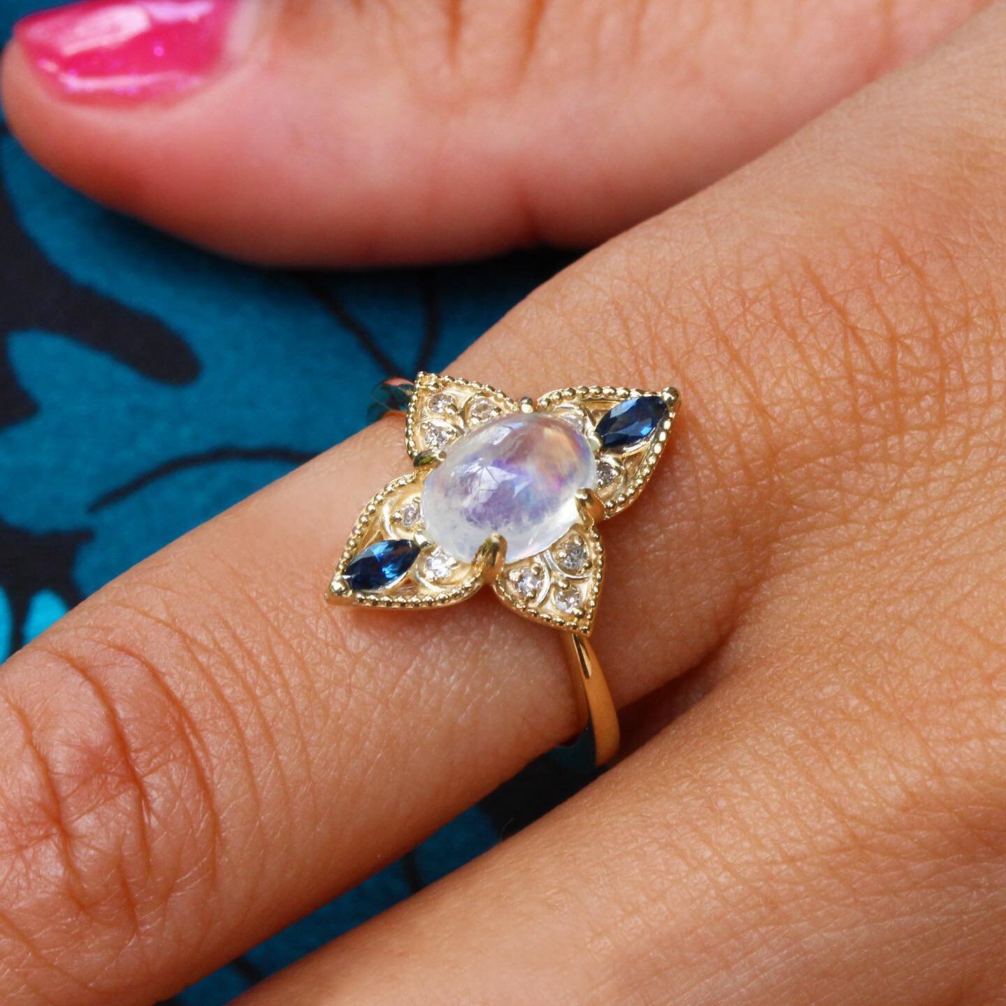 A magical Rainbow Moonstone 🌈 (purchased in Jaipur - The Pink City) accented by natural Blue Sapphires &amp; Diamonds. A Village Jewelry original, crafted in 14k gold. ✨ $649. Size 7.