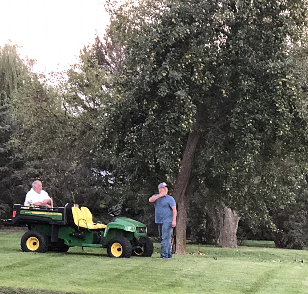  Shane (left) and our best bud, Junior, using the Gator to help with the harvest under the infamous pear tree. 