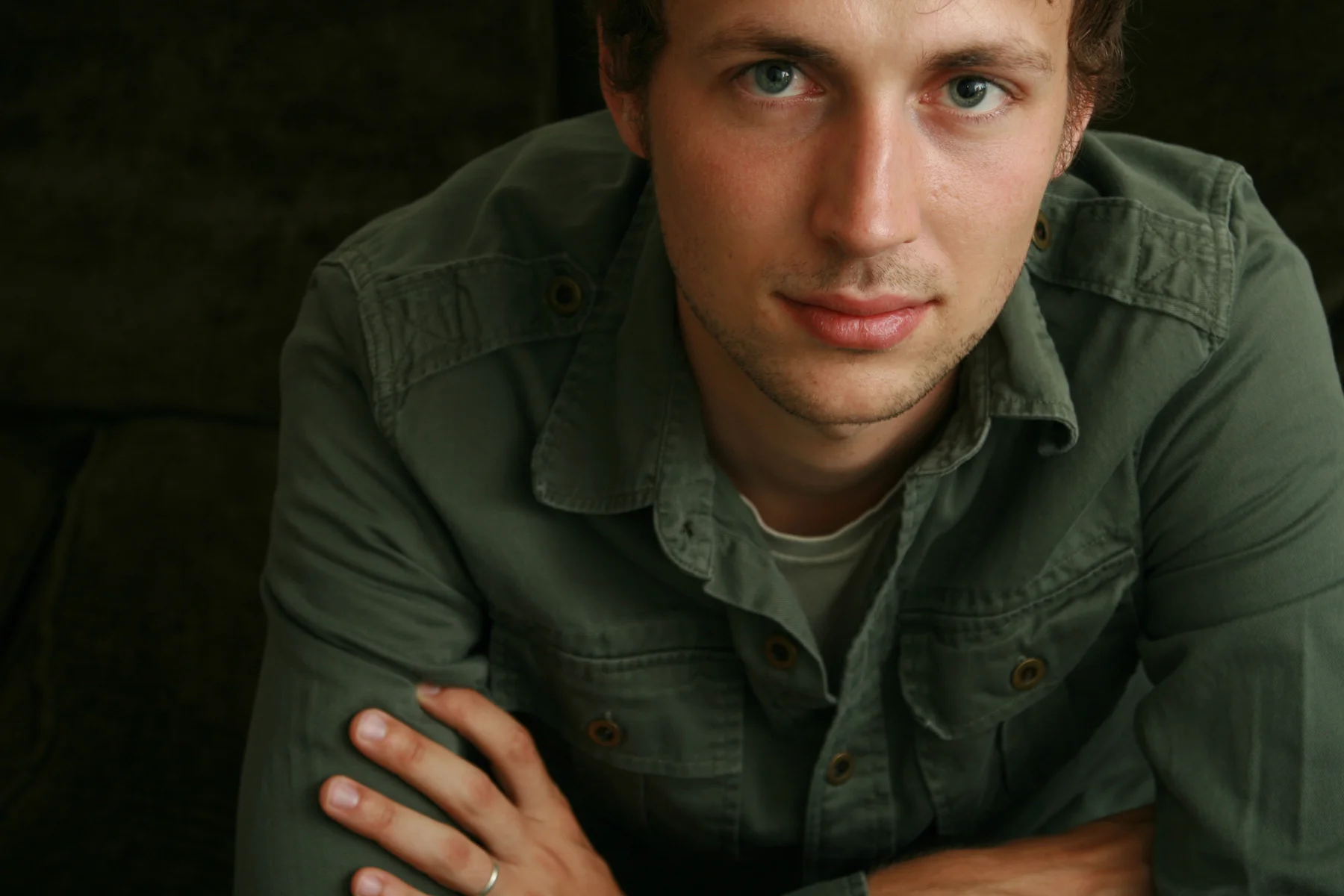 young man in green shirt on black.jpg