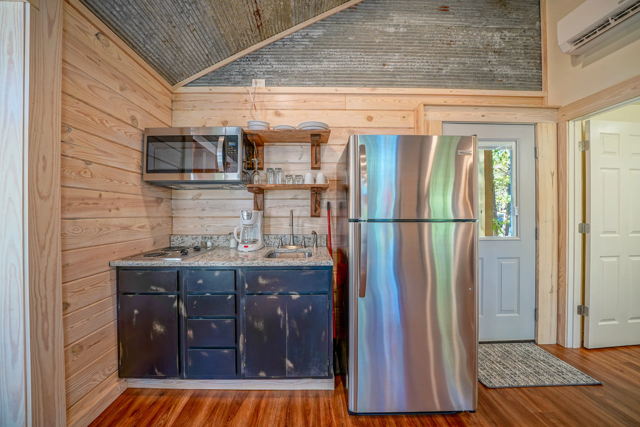 Kitchenette with stove, microwave, coffee maker