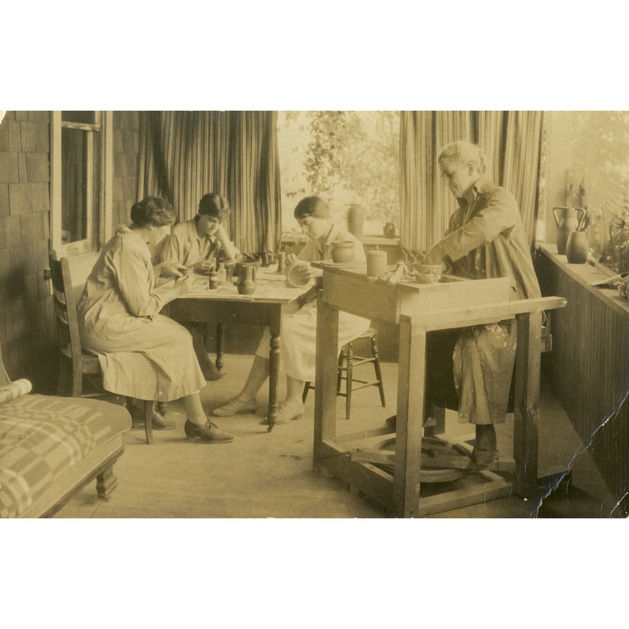 Marion Cartwright, Doris Cordy, Mrs. Eckersley, and Mrs. Croil Sr. working at the Log Cabin pottery studio, 1925