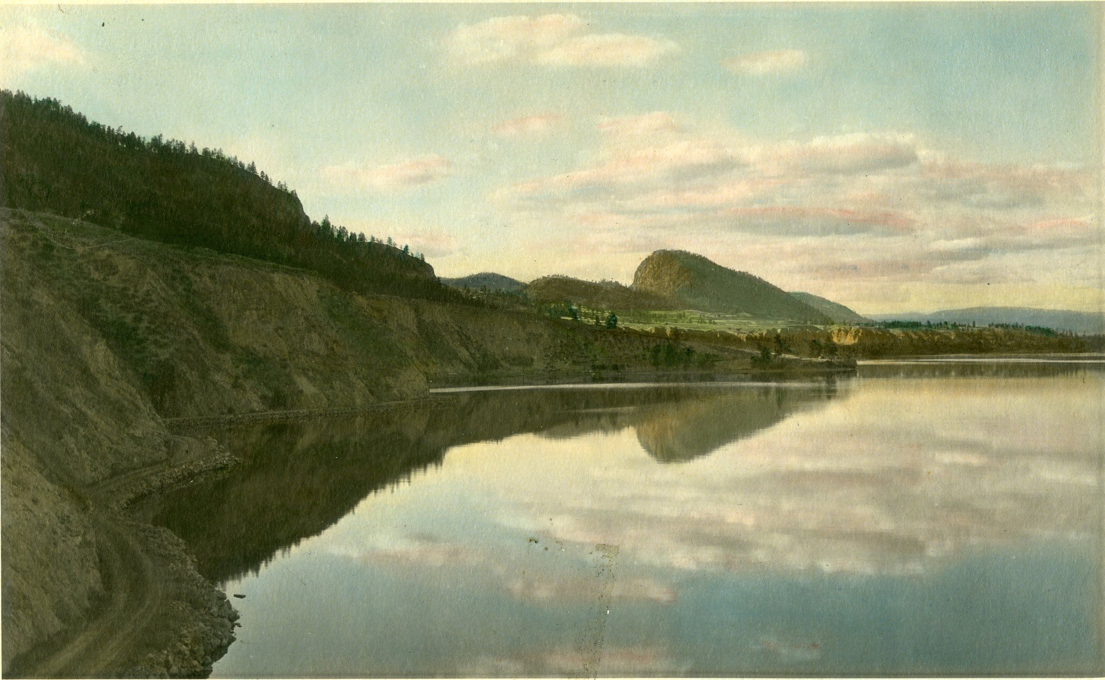 In honour of Earth Week, today's Throwback Thursday simply celebrates the natural beauty of Summerland.
This photo from c.1915 shows the road along the shore of Okanagan Lake between Penticton and Summerland. The photographer is looking north to Summ