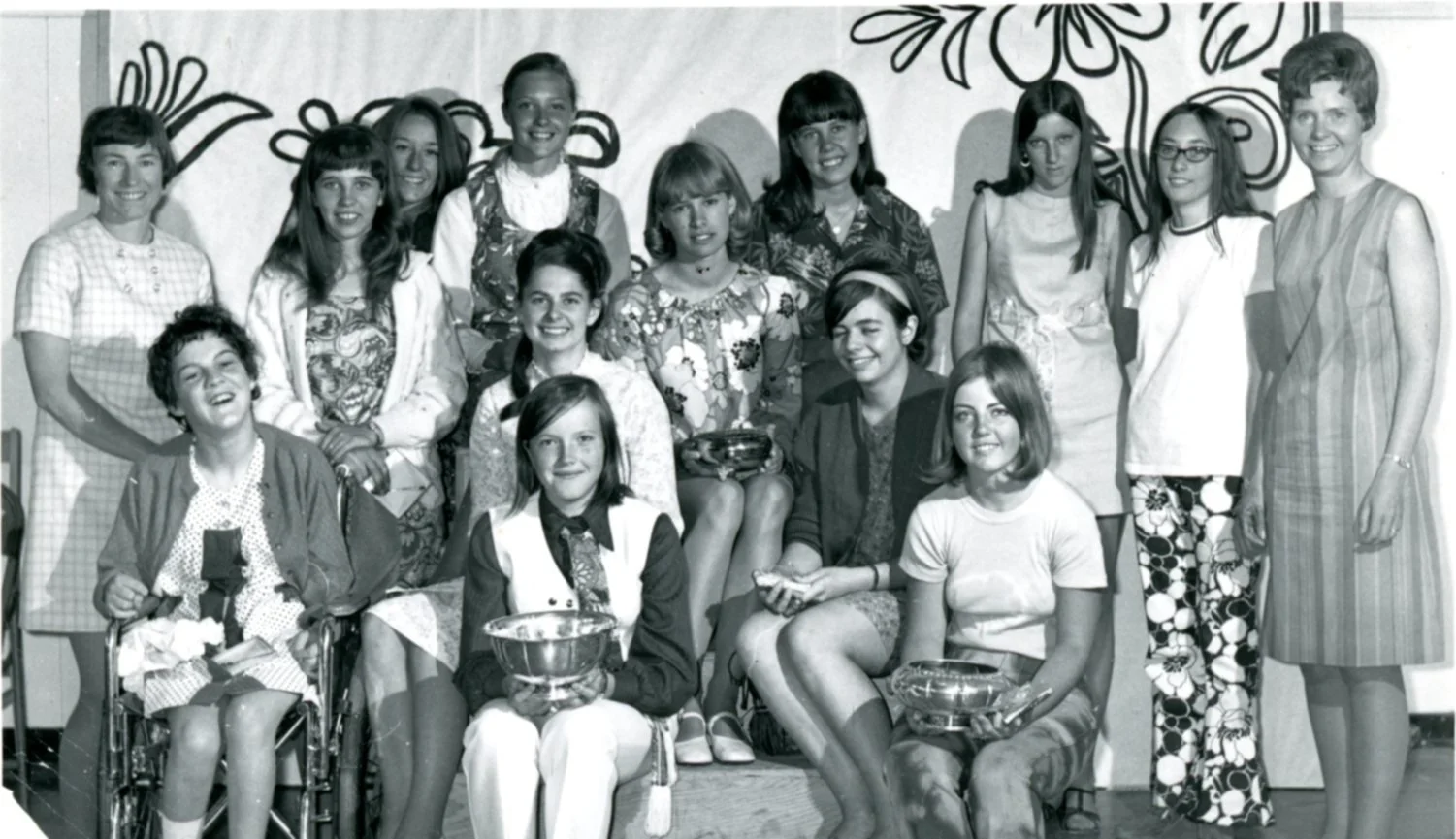For the first Throwback Thursday of February, we thought it would be fun to share this wonderful photo from February 1970. 

The girls here are pictured posing with their teacher, for their Foods 11 Summerland High School class photo. Three of the gi