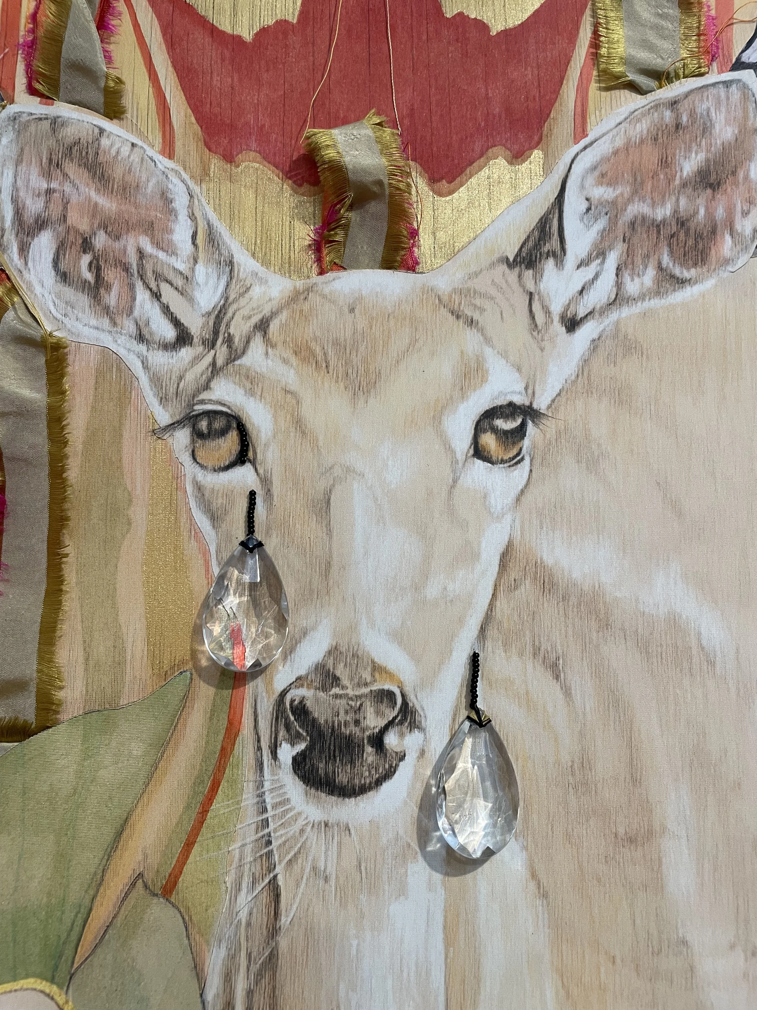 Close-up detail of White Tailed Deer with tear-drop shaped crystals dropping like tears from it's golden colored eyes.