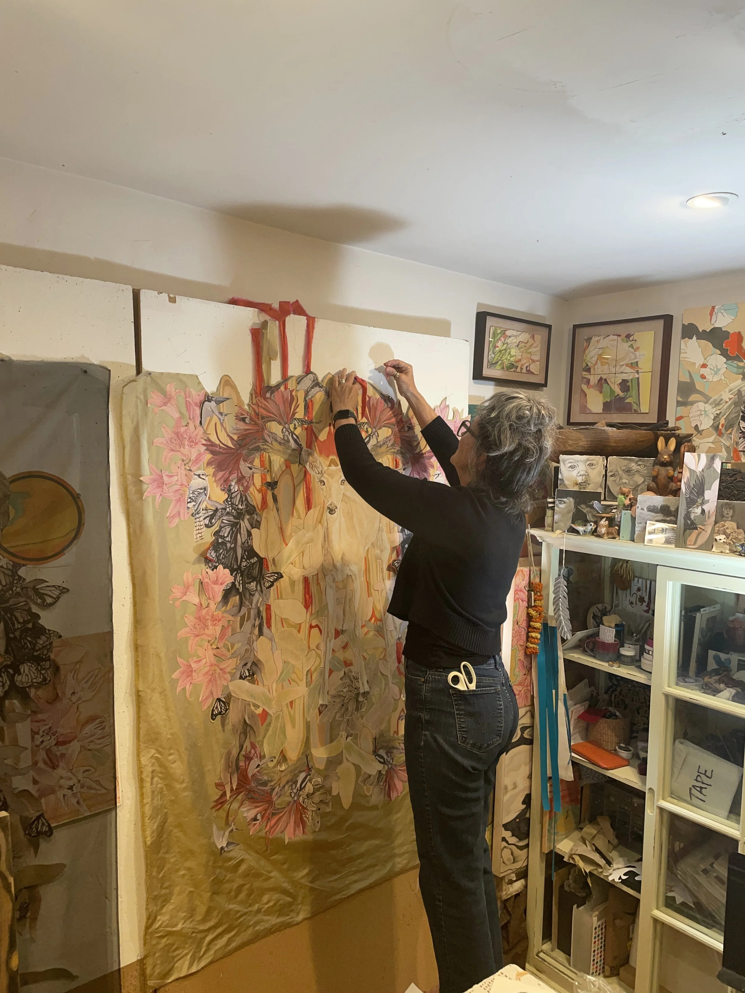 The artist in her studio working on a large fabric collage artwork.