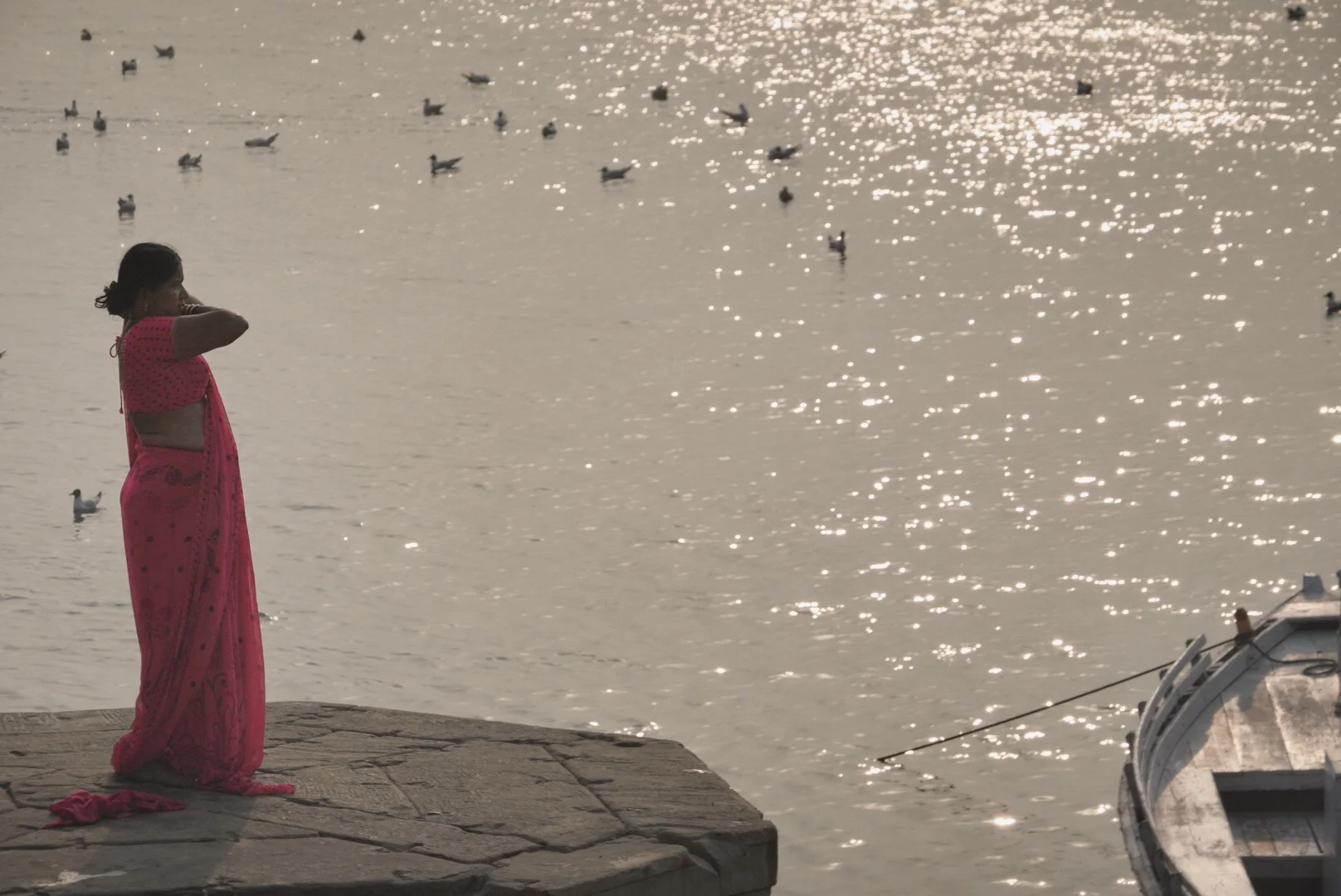 On the banks of the Ganges in Varanasi, India, people bathe, wash clothes and let them dry in the sun. This woman's process of wrapping a sari is so artful.