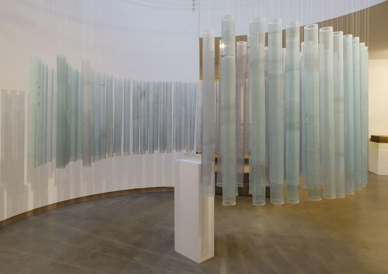 Mt. Waddington Reliquary (2013). Installation by artist Anna McKee at Museum of Northwest Art, La Conner, WA. Dyed and printed silk, glass ampules, melted glacial ice water, wood, silver foil, fiberglass, 8 channels of audio of dripping glacier ice. (photo: Anna McKee)