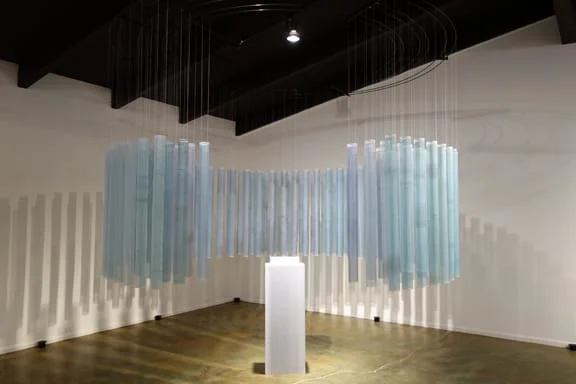 Mt. Waddington Reliquary (2013). Installation by artist Anna McKee at Francine Seders Gallery, Seattle. Dyed and printed silk, glass ampules, melted glacial ice water, wood, silver foil, fiberglass, 8 channels of audio of dripping glacier ice. (photo: Anna McKee)