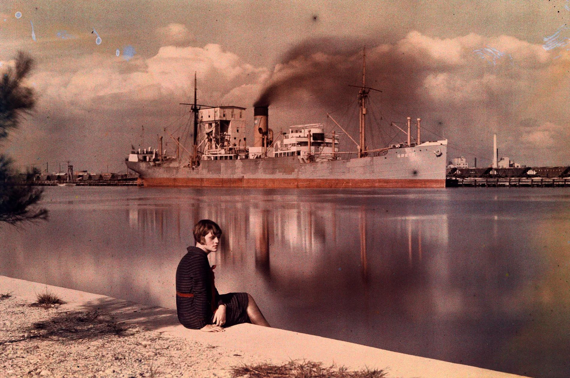 This photo of a woman sitting on the edge of a sea wall at a harbor in Tampa, Florida, appeared in the 1930 National Geographic article "Florida—The Fountain of Youth."