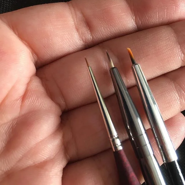 In contest against myself to get the smallest paintbrush available. I won, my bank account lost.