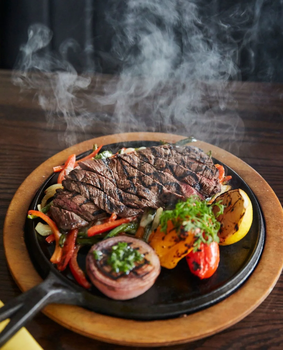 Steak, but make it fun; tender skirt steak with warm tortillas, creamy guac, smoky morita salsa, and melted cheese on the side.