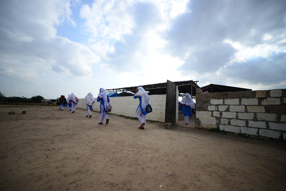 Female students leaving an open-air Pehli Kiran School. Click photo to enlarge.