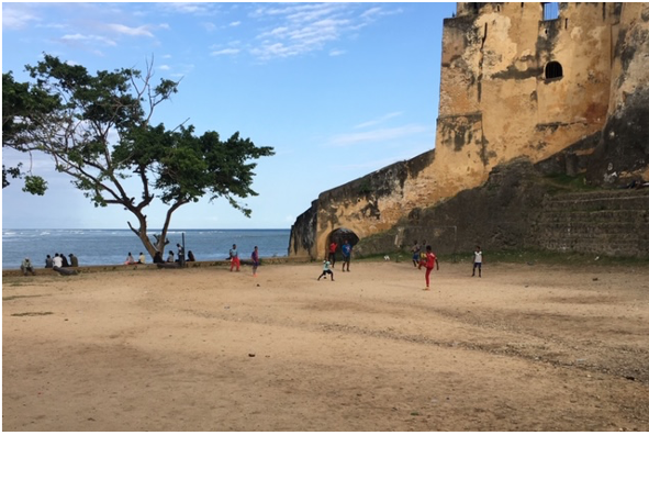 Figure 2: Kids play soccer on the beach below Fort Jesus in Mombasa’s Old Town. Photo by Ella Duncan. Click to enlarge.