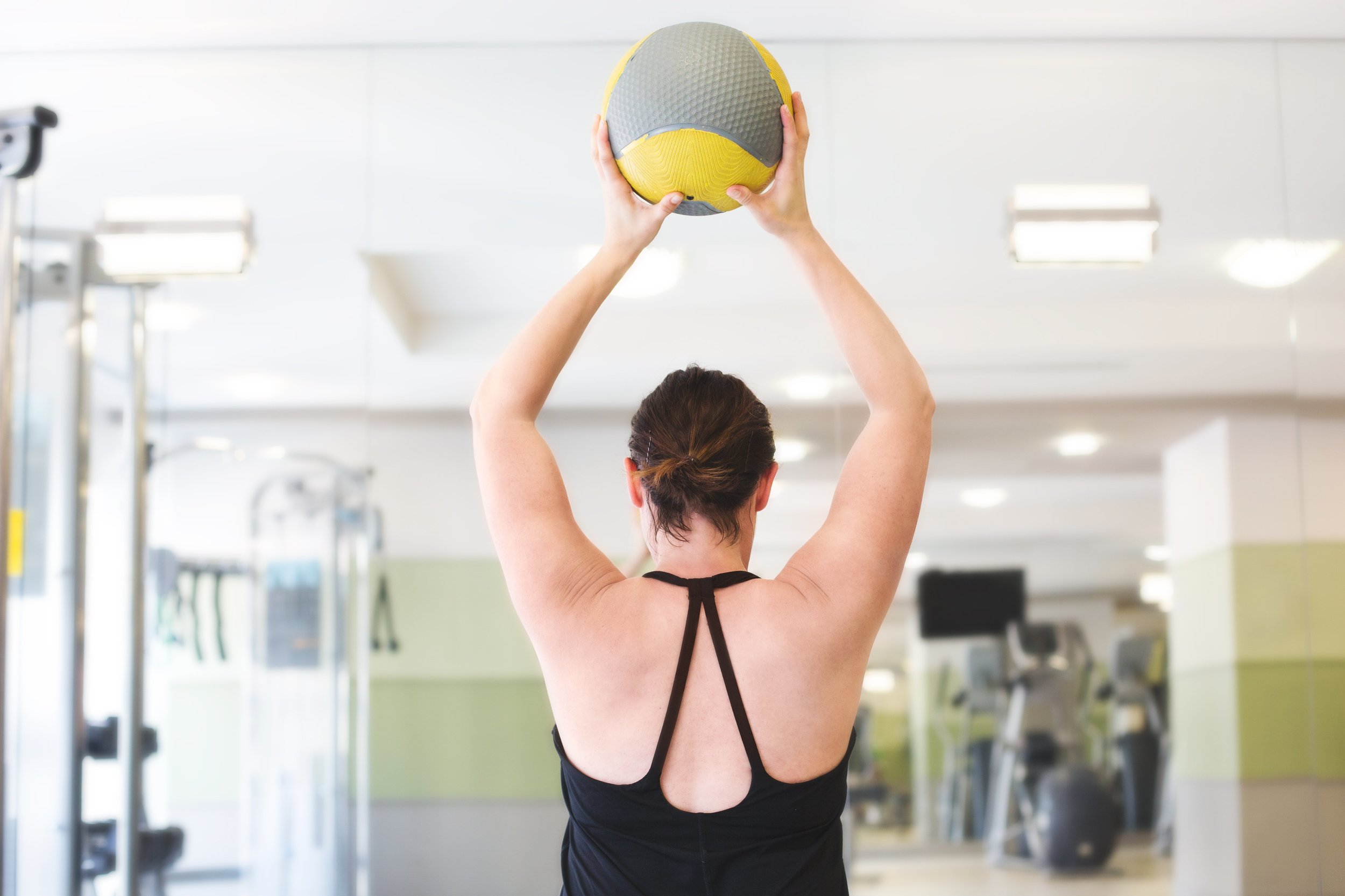 woman-lifting-fitness-ball_4460x4460.jpg