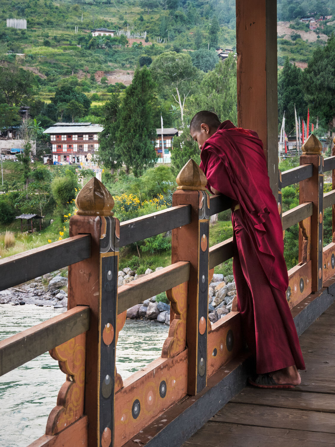 Buddhist monk in bridge to Punakha Monastery