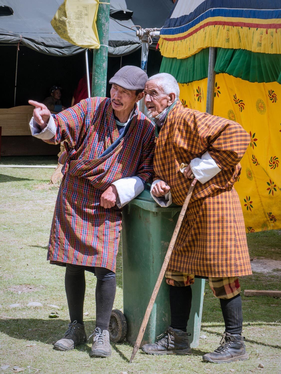 Two older men wearing traditional Bhutanese clothing