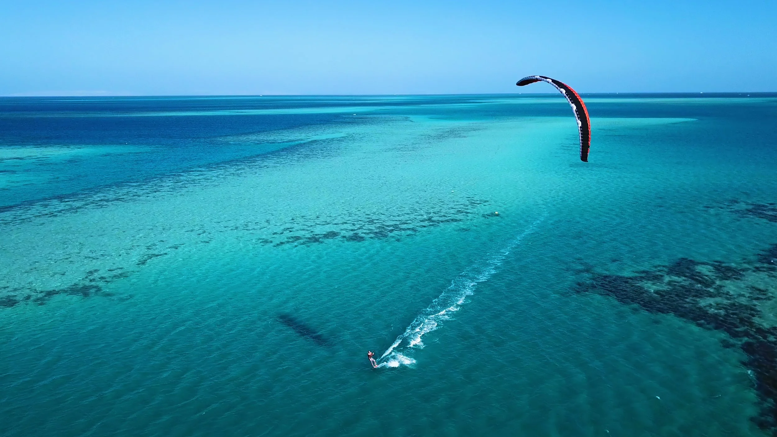 A person parasailing in an abundant ocean