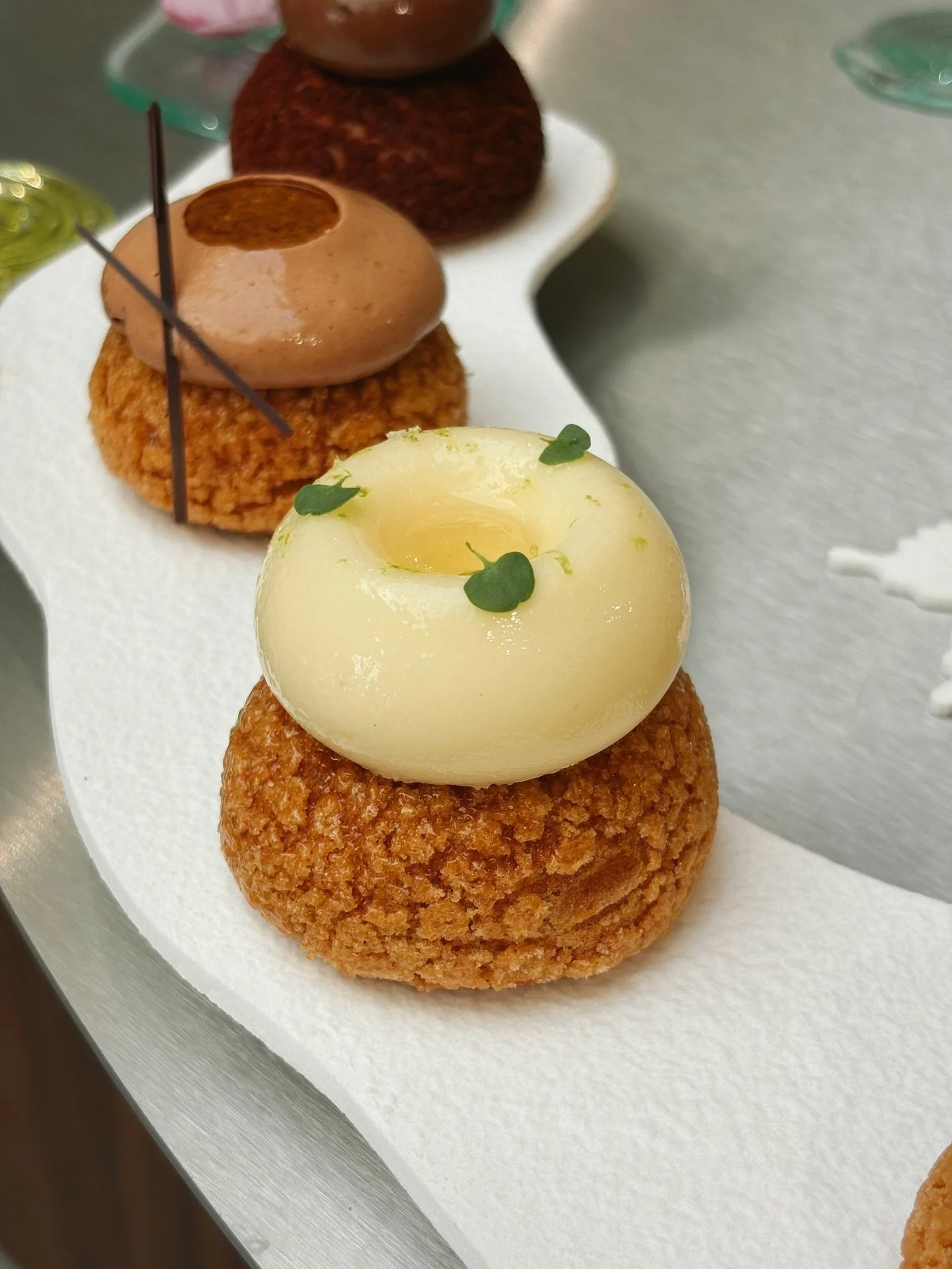 Creamy lemon p&acirc;te &agrave; choux featuring craquelin, confit de citron, and a cr&eacute;meux au citron. Made with @remaki_nadir during the historic Paris heatwave in June. 🍋

@bellouetparis