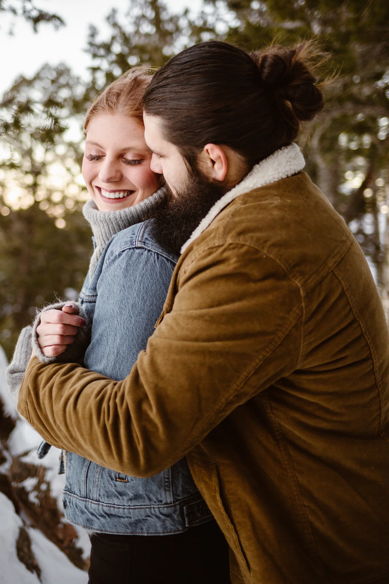 couple laughing snowy engagement photos