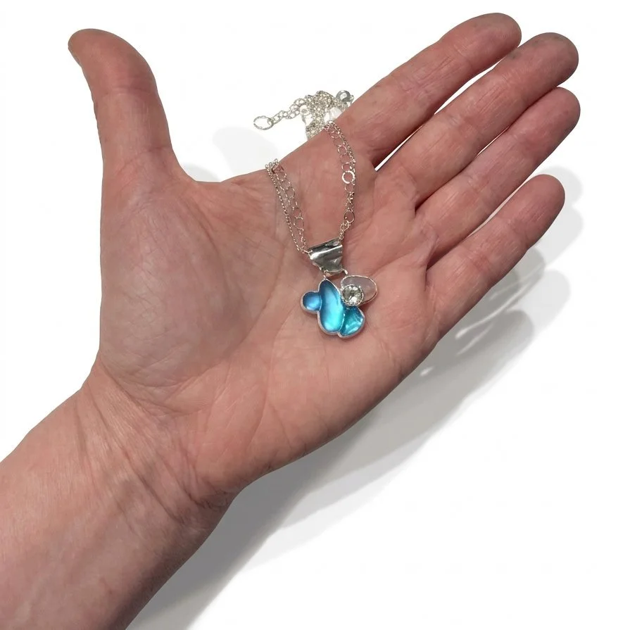 Translucent-sky-pendant-in-hand-for-scale.jpg