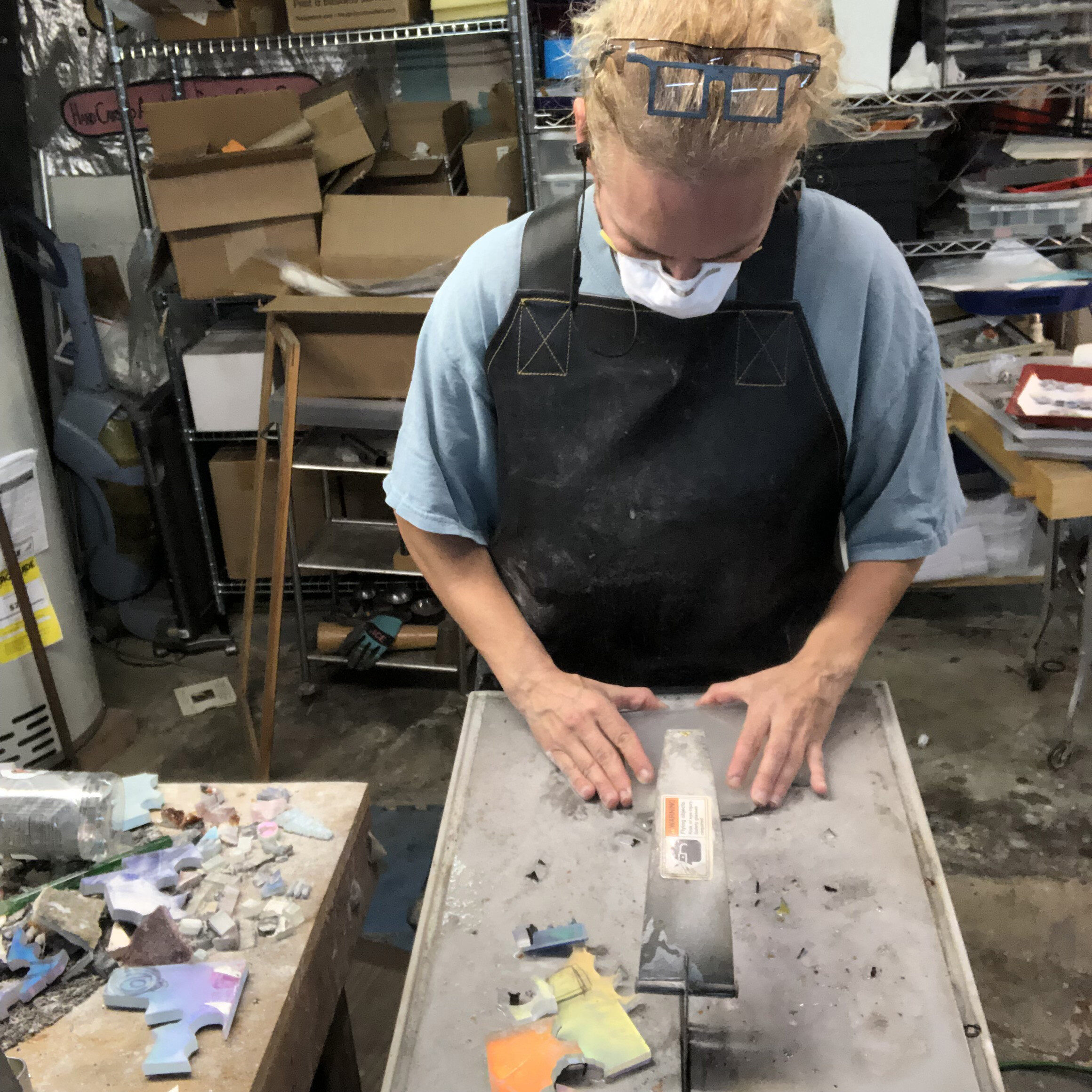 Using a wet diamond saw to cut glass.