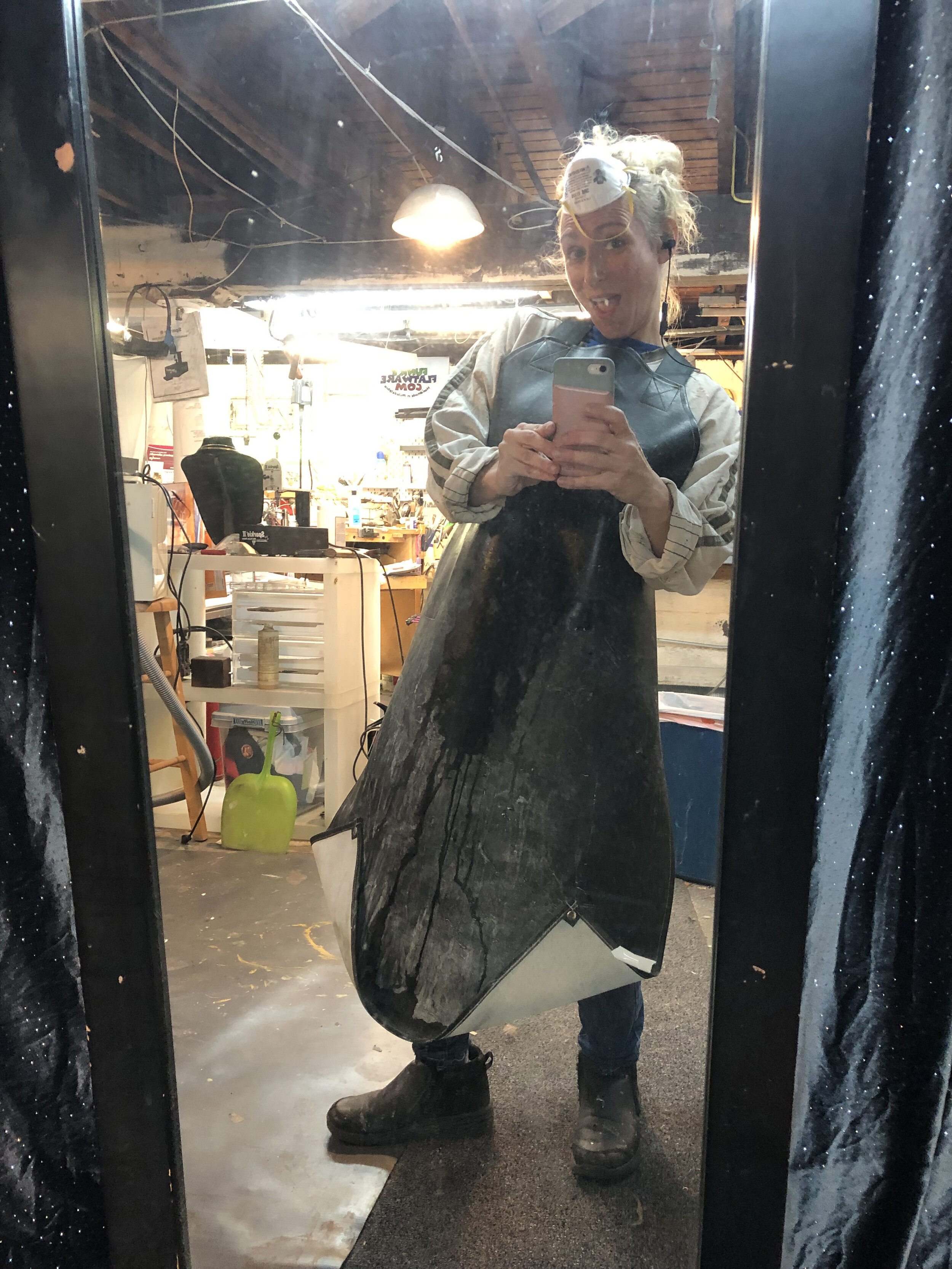 I wear a stylish rubber apron while I work with the glass as well as rubber boots because my process involves a lot of water to keep the glass cool.