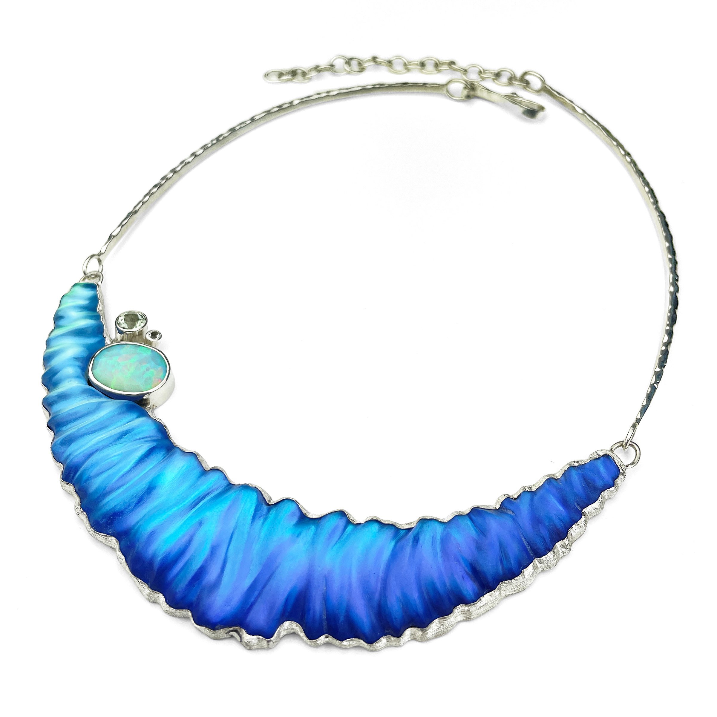 This one-of-a-kind necklace, inspired by the ocean's beauty, features a unique blend of hand-carved glass, sterling silver, and genuine opal and green amethyst.