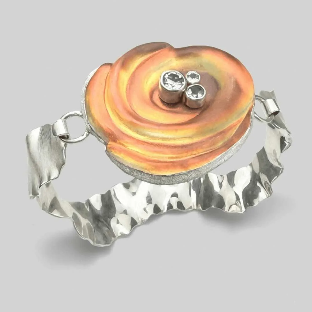 A sterling silver and orange carved glass cuff bracelet with genuine topaz.