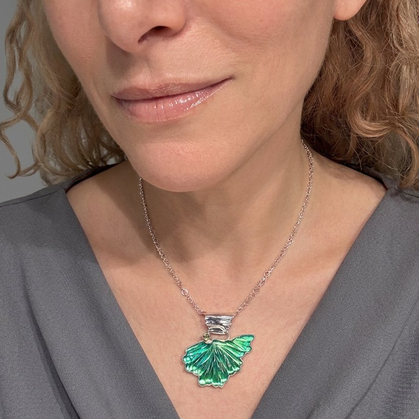 flight-pendant-green-carved-glass-sterling-silver-peridot-on-model.jpg