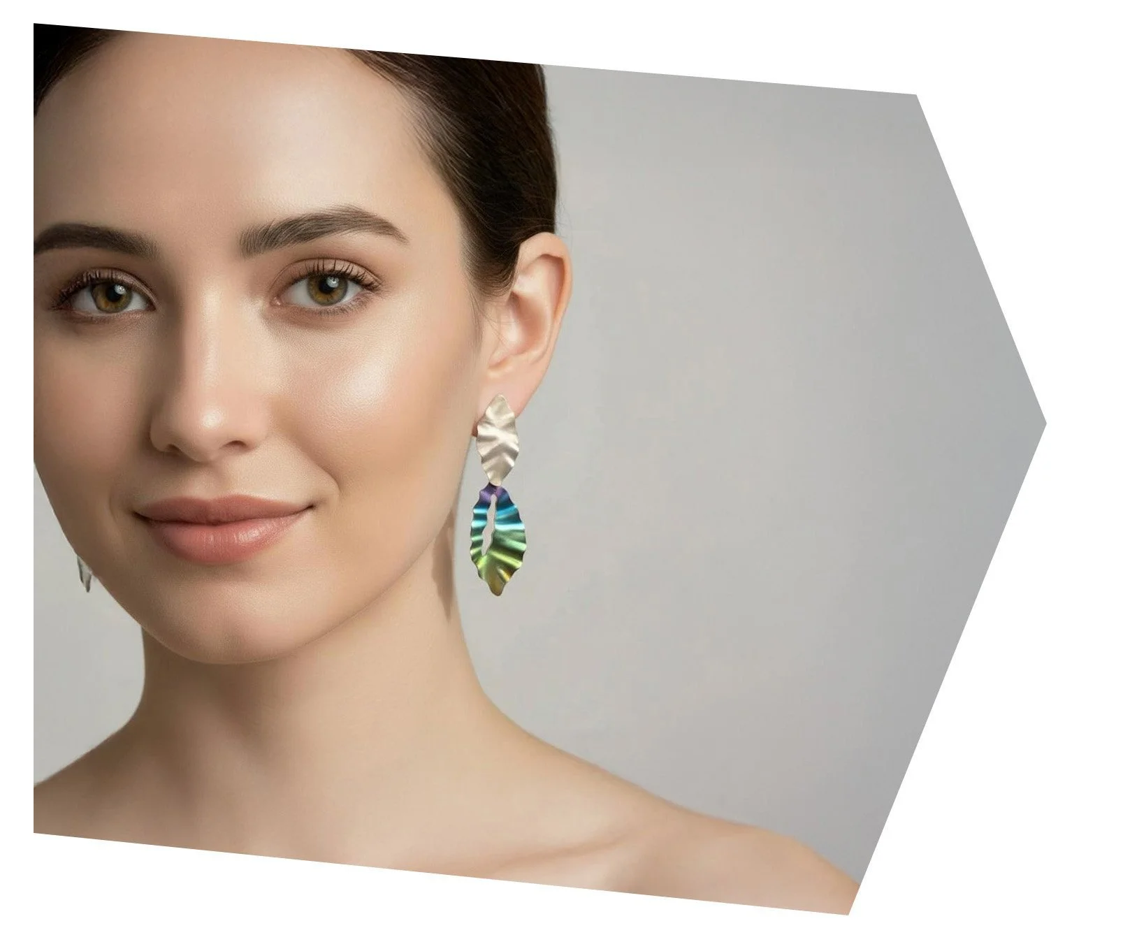 Close-up portrait of a woman with fair skin, light makeup, light brown hair pulled back, wearing colorful, metallic leaf-shaped earrings, against a light gray background with a geometric overlay.