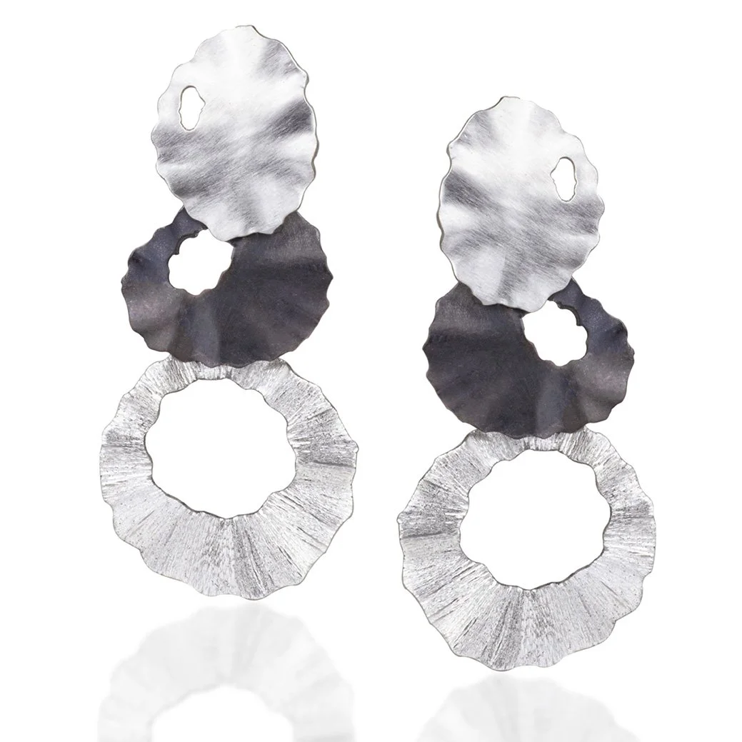A pair of sterling silver 3 tiered clip earrings.