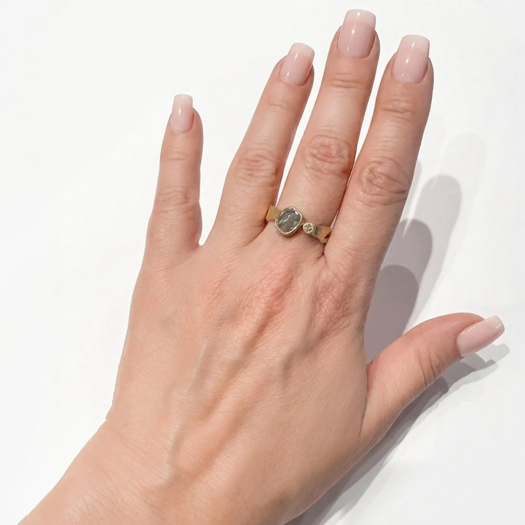 Holding-Light-gold-silver-diamond-ring-on-model-hand.jpg
