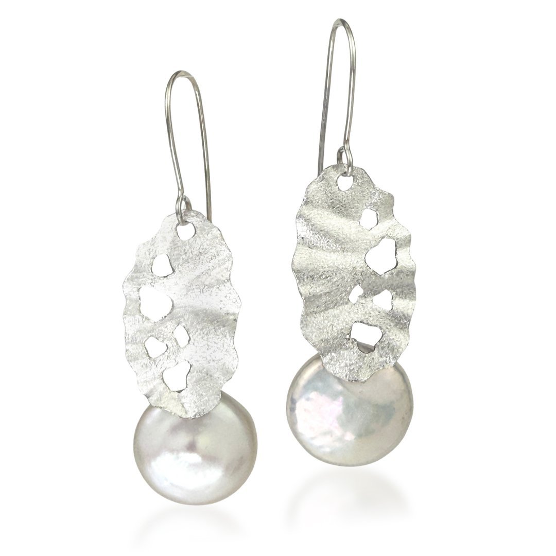 Sculptural sterling silver earrings with pierced texture and round freshwater pearl drops.