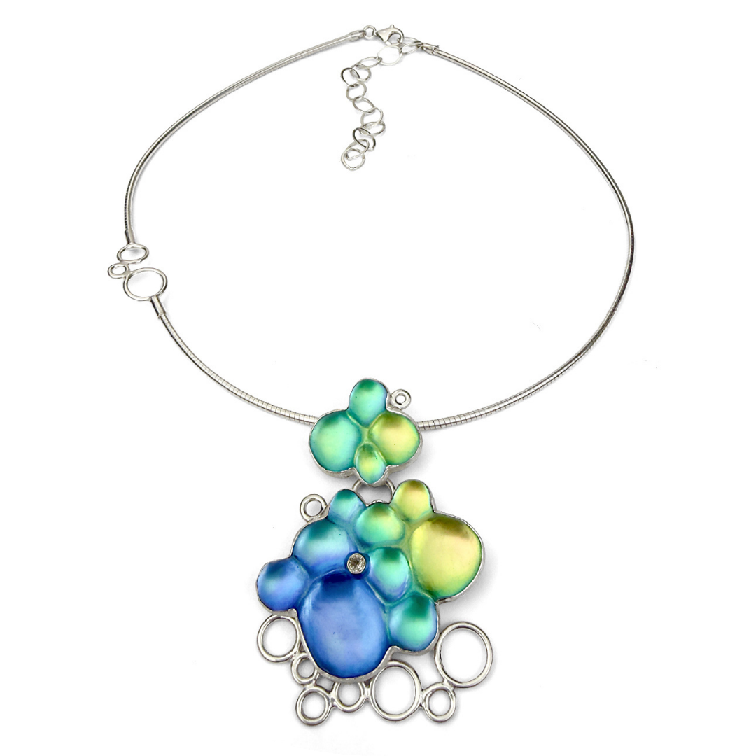 A colorful carved glass and sterling silver necklace.