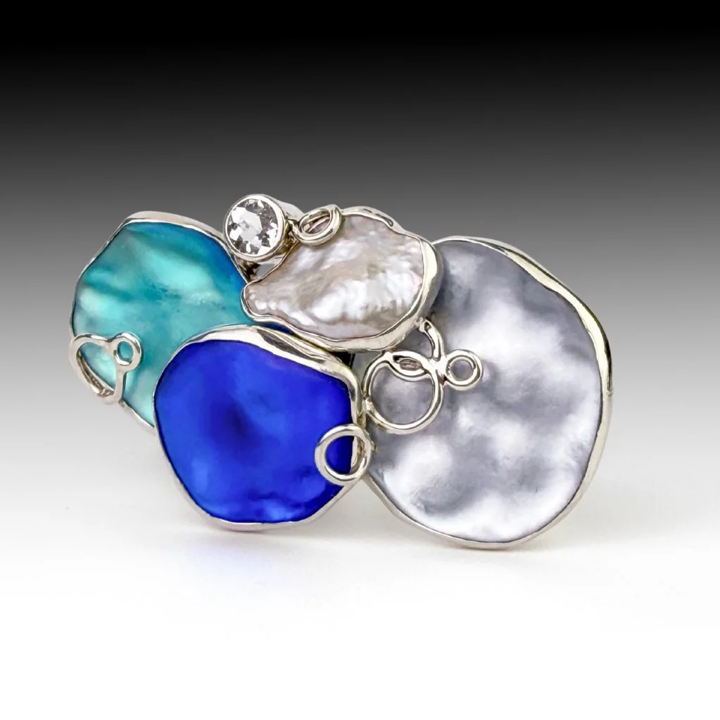 A carved glass, sterling silver, pearl, and topaz convertible brooch.