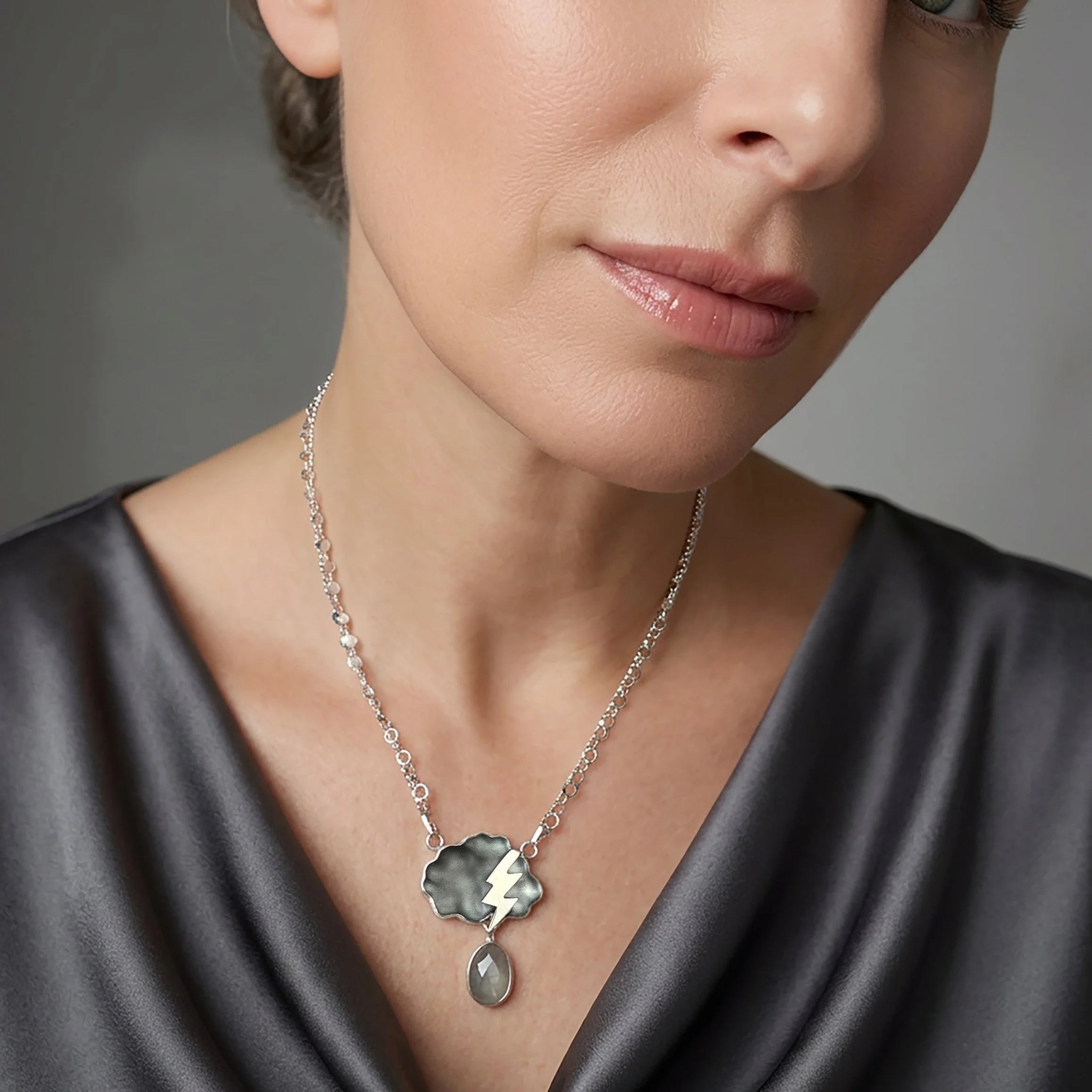 thunderhead-necklace-glass-and-aquamarine-cloud-with-thunderbolt-and-lightening-on-model-6ade44540a428.jpg