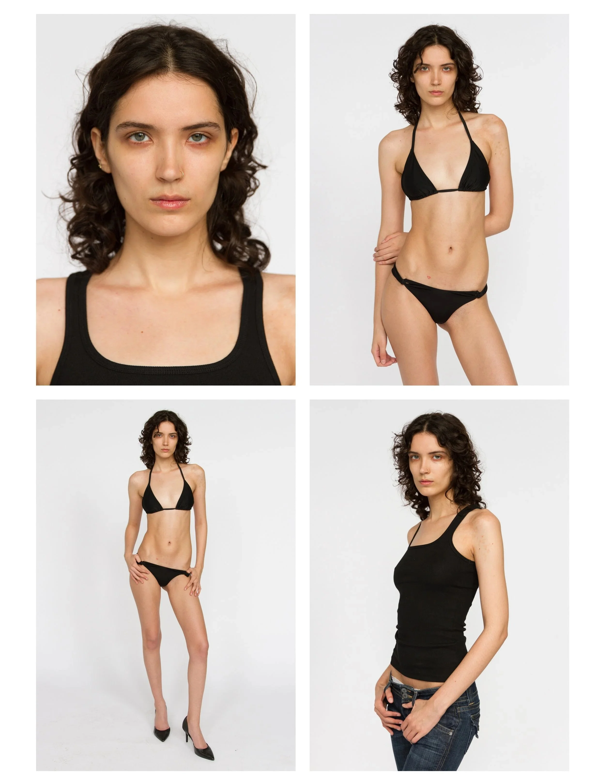 A young woman with curly dark hair posing in a black bikini, standing with one hand on her hip, at a photo shoot against a plain white background. Model Digitals