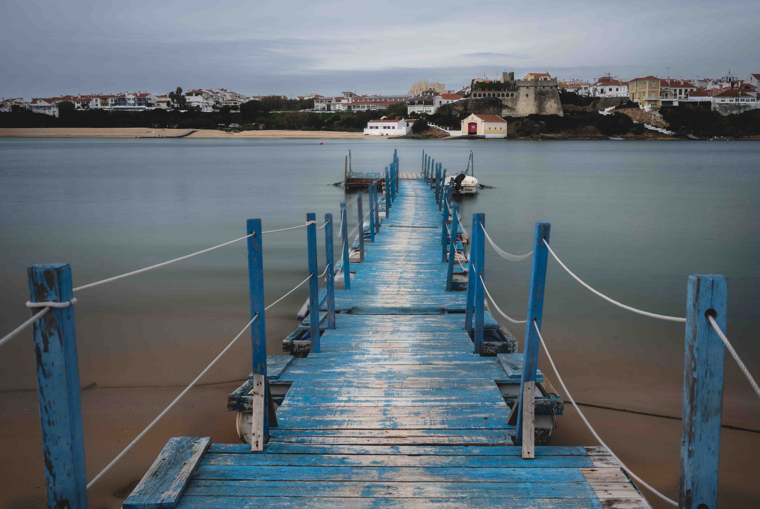 Blue jetty leading to a fort in Vila Nova de Milfontes
