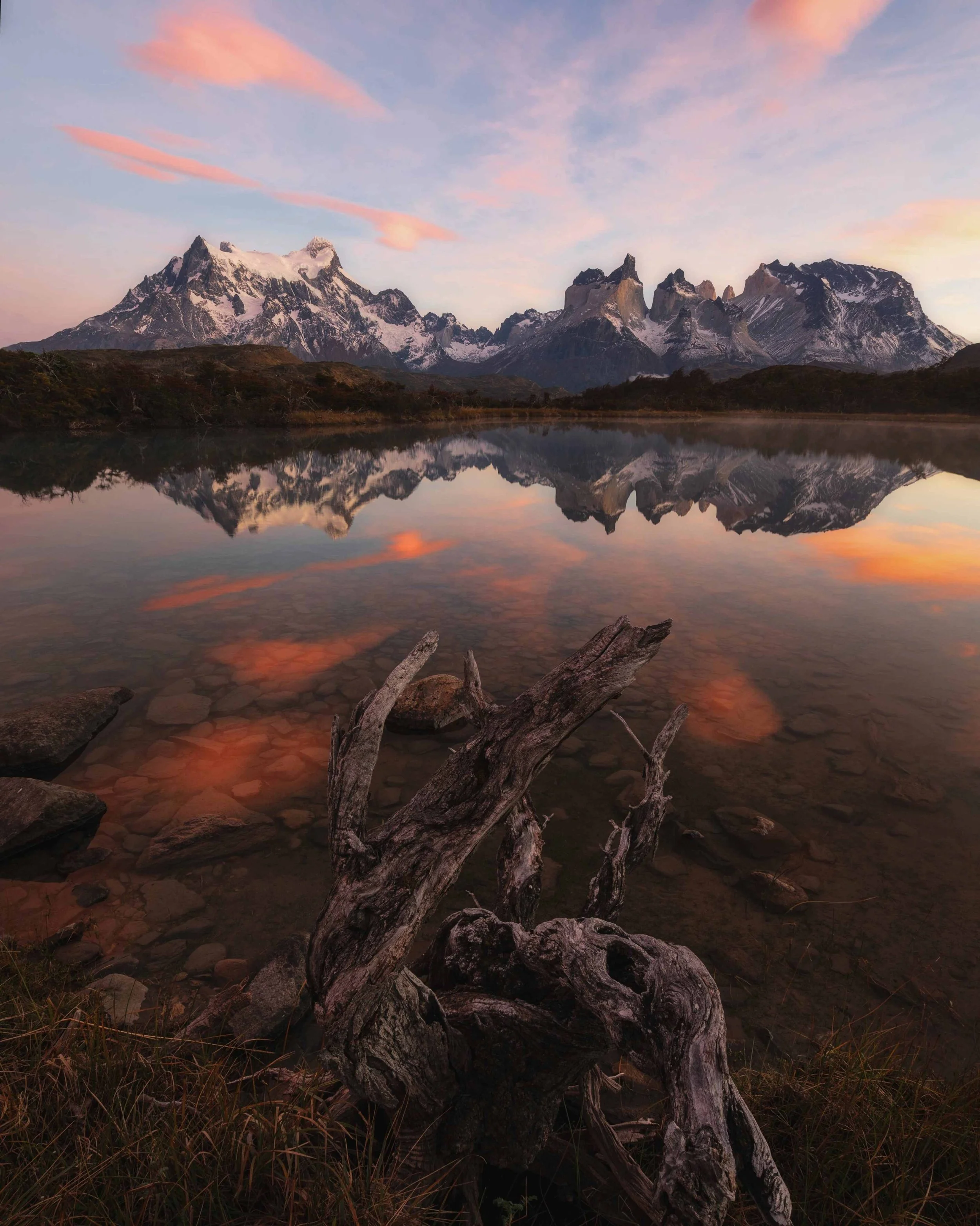 Reflection of Torres del Paine peaks during sunrise in Patagonia 