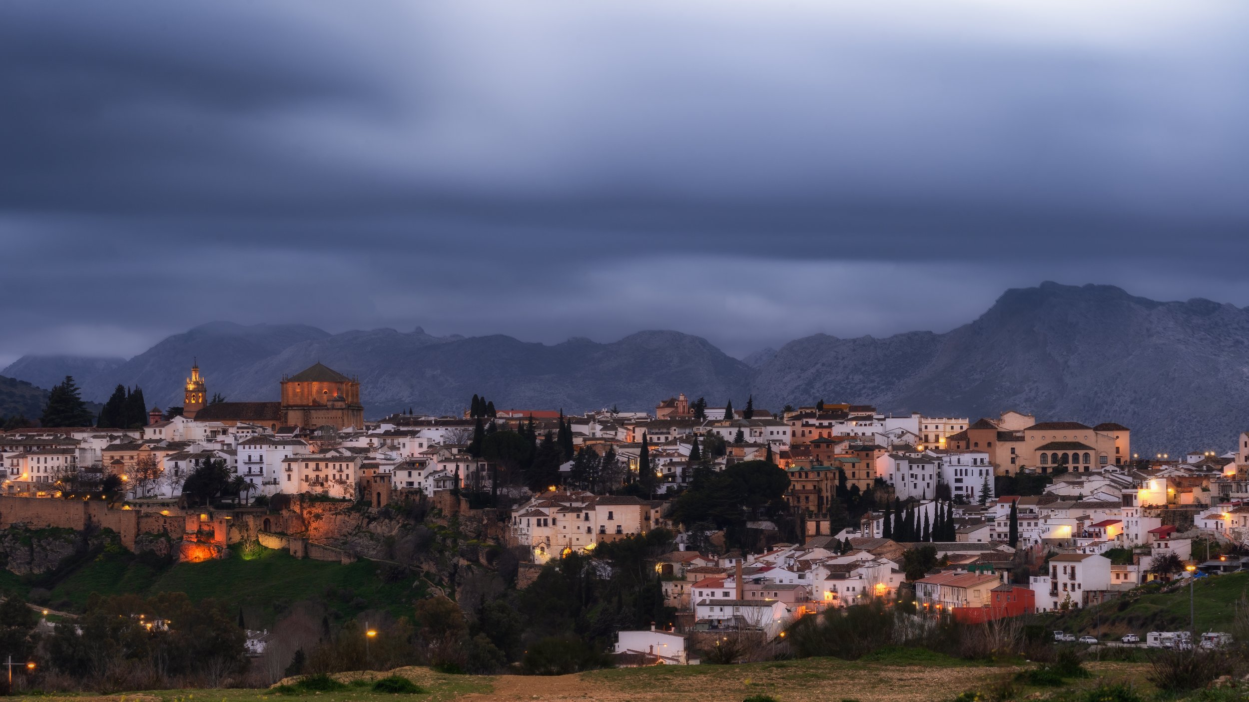 Strong blue hour photograph of the bridge in Ronda