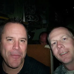 Here's a pic of me with Vince Flynn from this spring. He was gracious enough to fly out to Washington for a town hall meeting with our Governor to see the Red Bulls!! As a crew member I was very excited to have the Governor fly with us but while waiting outside the plane I saw Vince standing with the Governor and totally blew off the Governor to shake Vince's hand....as I have read every book and am a HUGE FAN!!!!!!! After a long flight and day even though he was tired, Vince took the time to talk to me personally about my deployments. I thanked him because his books got me back into reading!! Thank you SSGT Paul H. Jensen
