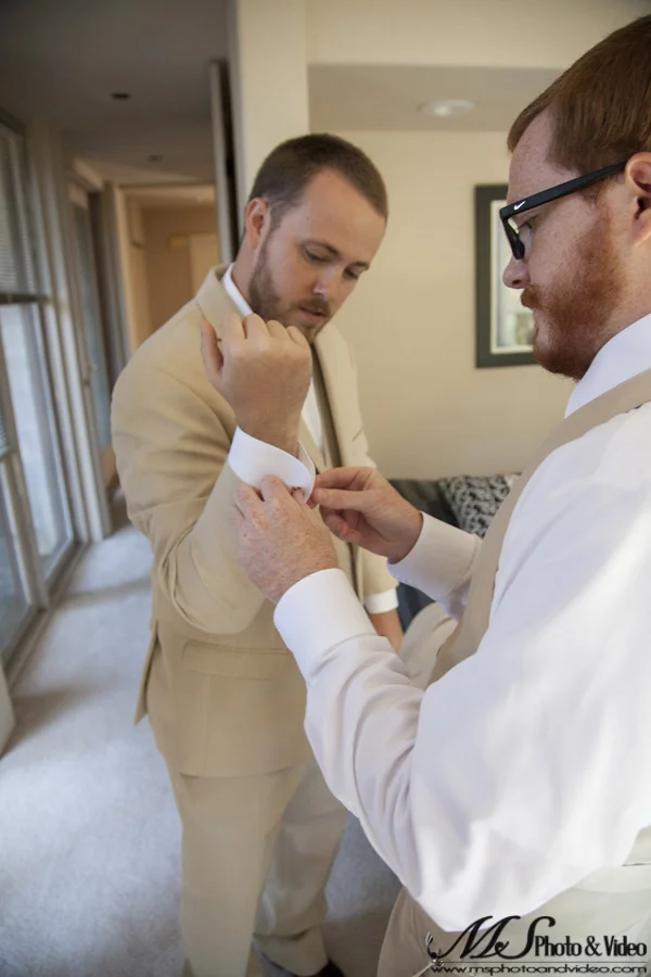 Best man helping the groom