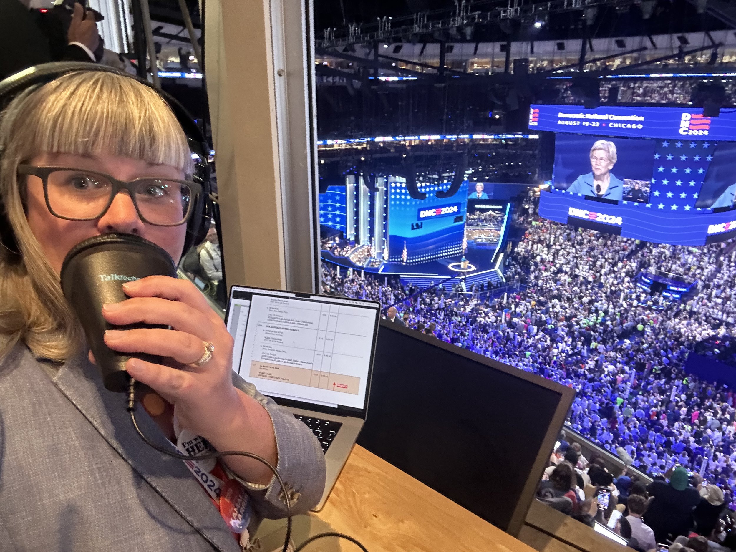 Bridget at the DNC 2024 using a stenographers mask to describe the arena event below.