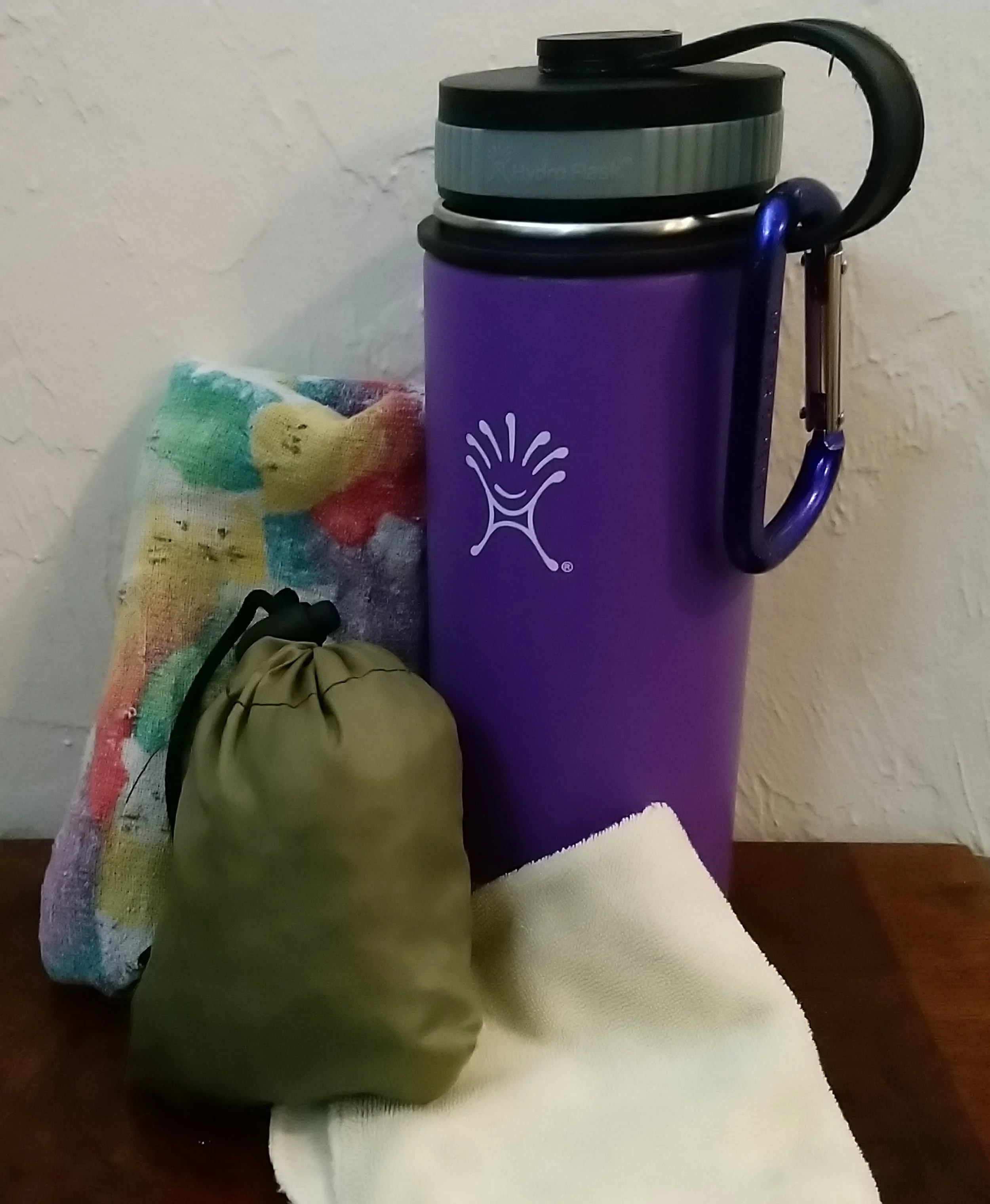 My most used travel items - water bottle, ChicoBag, napkin, and small multi-purpose cloth